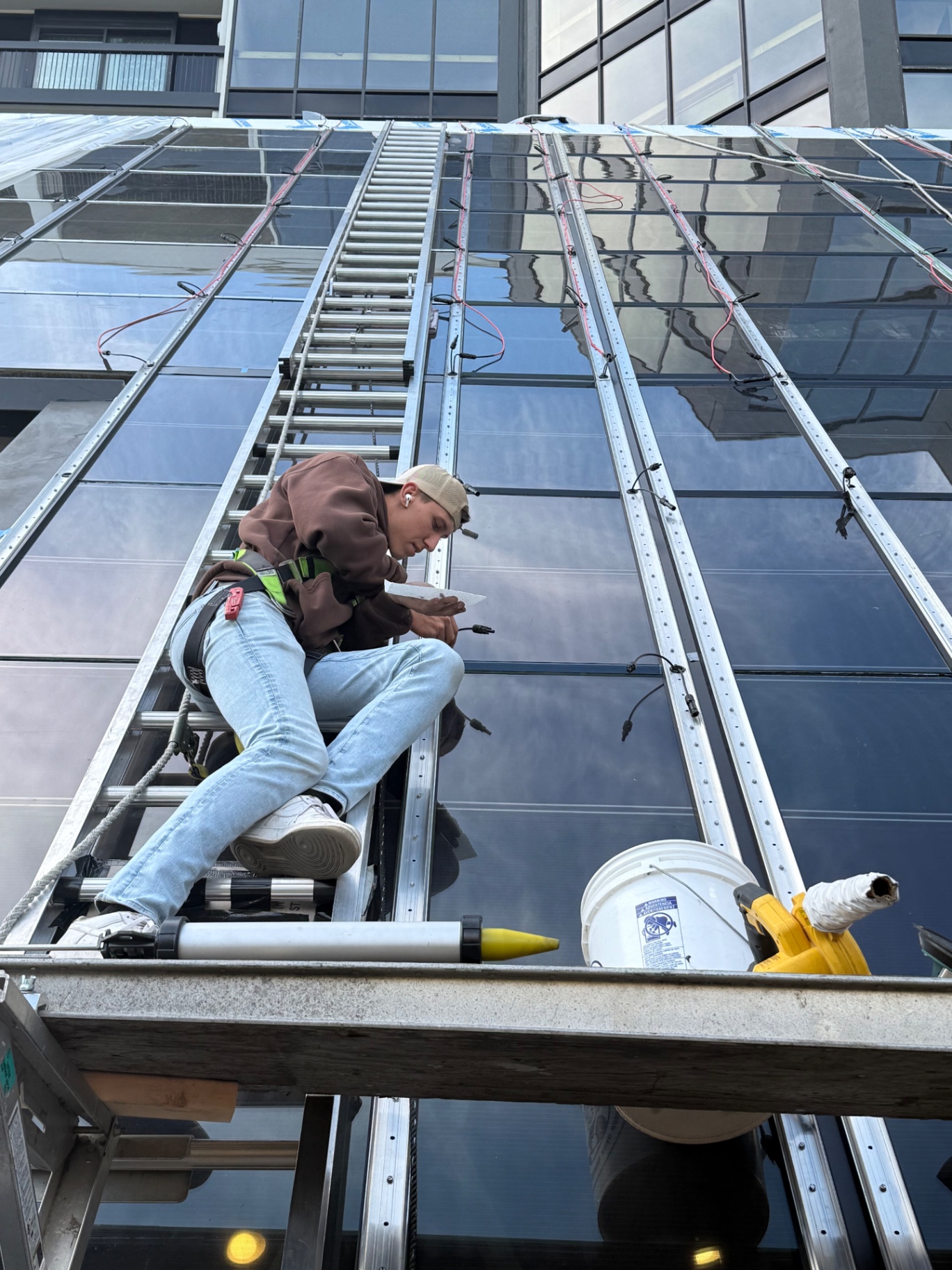 Technician sealing glazing on a commercial skylight